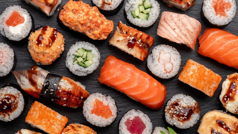 Assorted,sushi,nigiri,and,maki,big,set,on,slate.,a